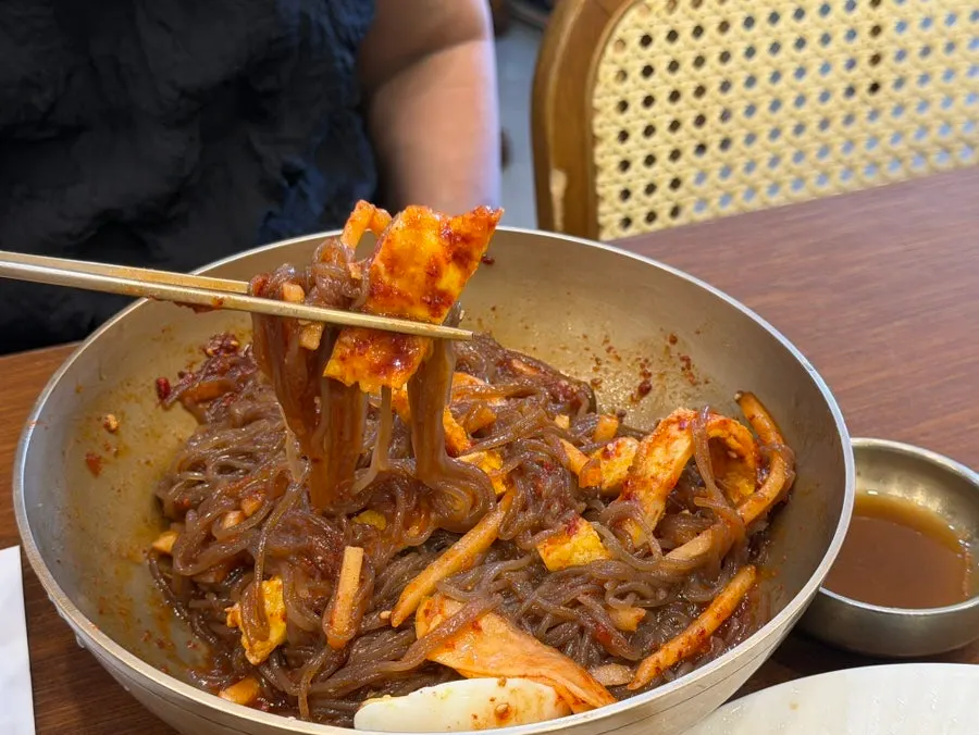 Bibim naengmyeon topped with sauce and ujeon garnish