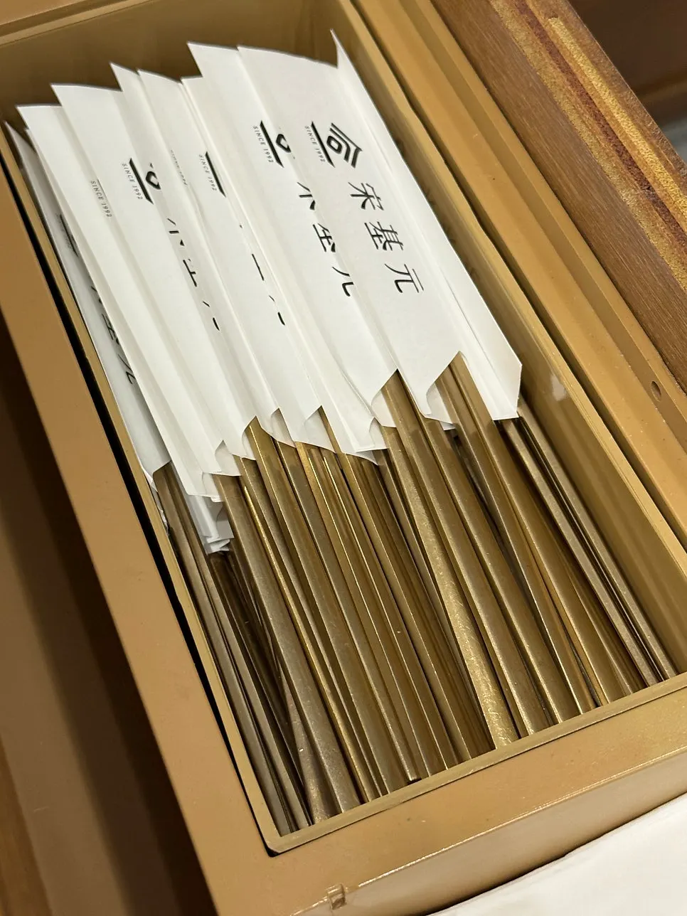 Vinegar, mustard, and individually wrapped chopsticks on the table