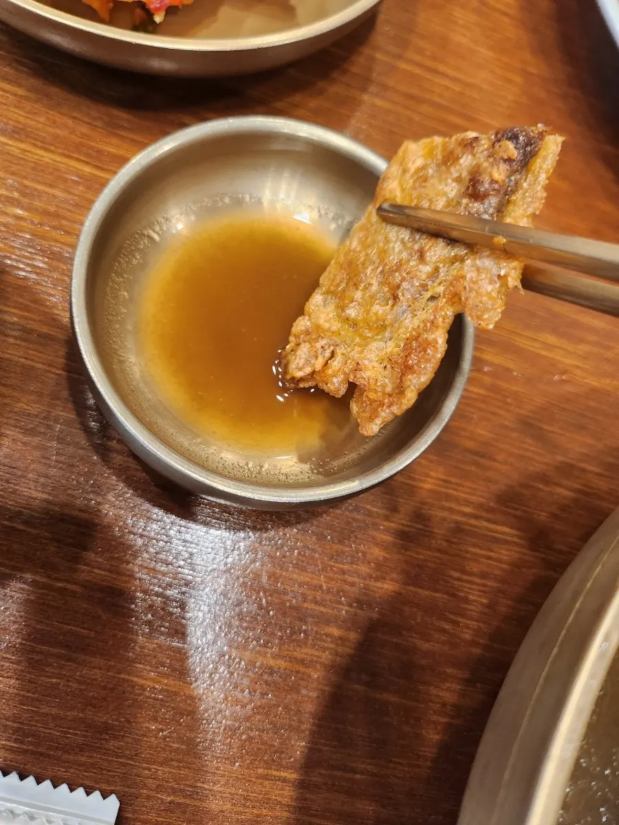 A piece of yukjeon lifted up
