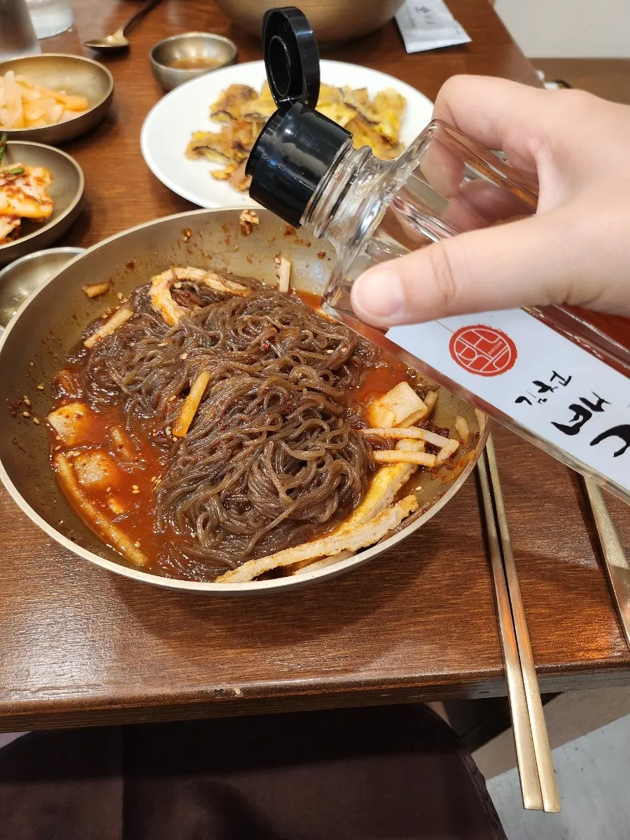 Mixed naengmyeon noodles blended with sauce and broth