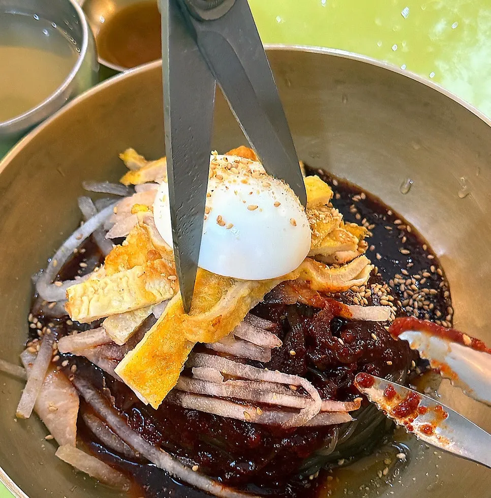 Buckwheat bibim-naengmyeon topped with sweet-spicy sauce