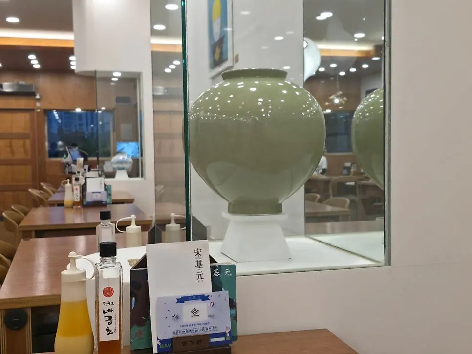 Interior of Songgiwon Jinju Naengmyeon Direct Store with generously spaced tables