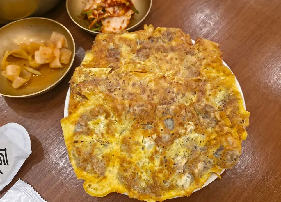 Two basic kimchi side dishes and a glass of cold water