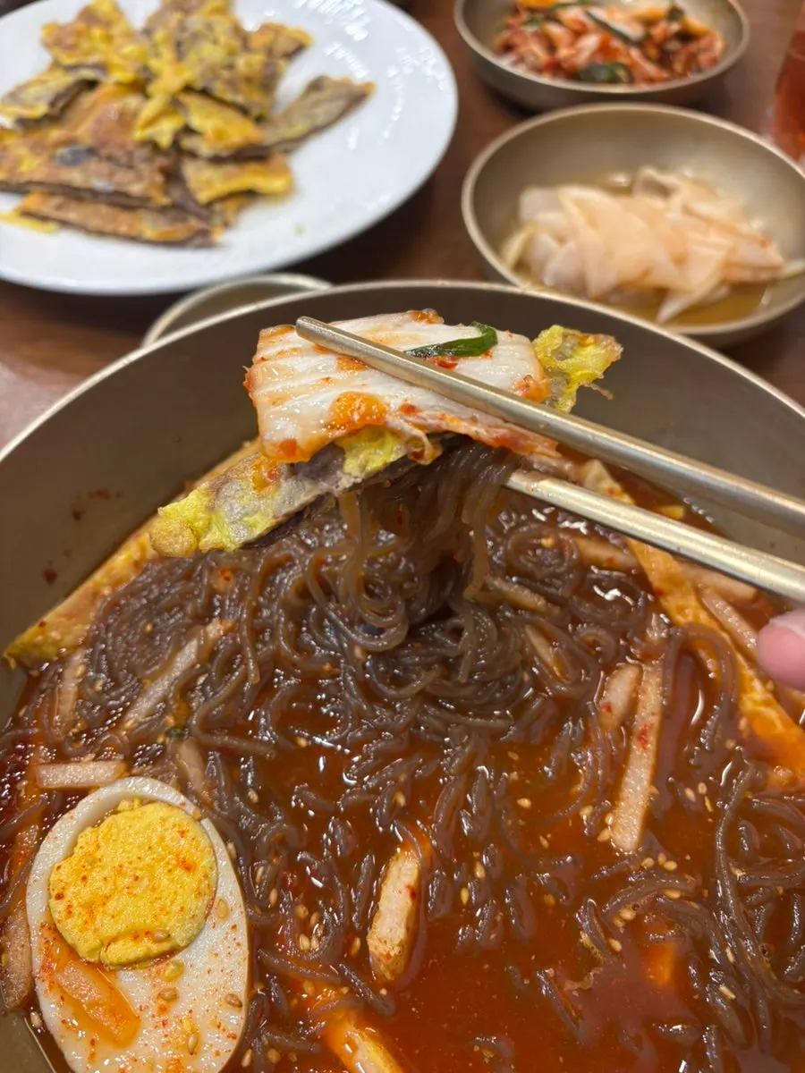 A generous pile of beef yukjeon topping over the noodles