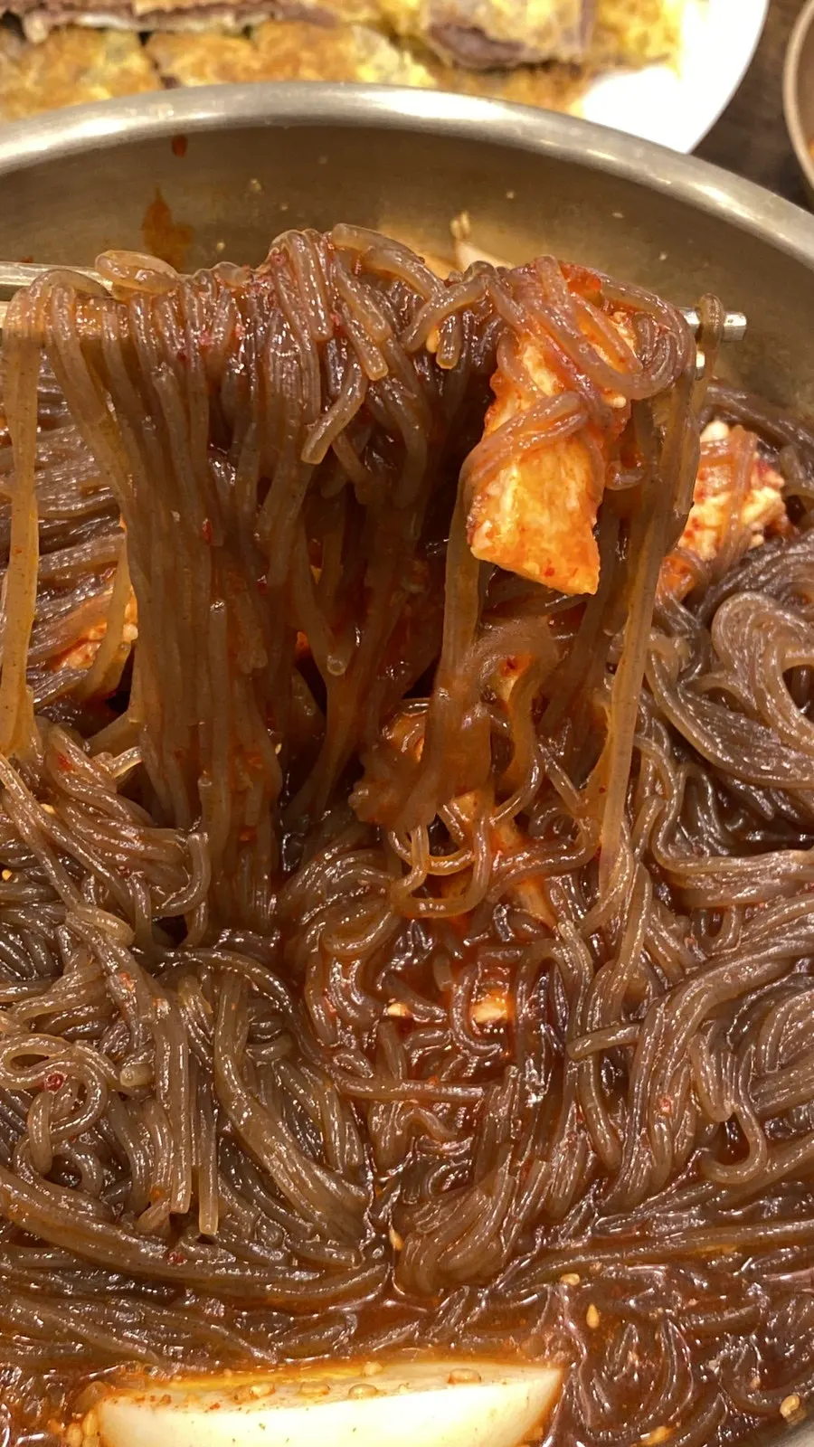 Wrapping the naengmyeon noodles with yukjeon