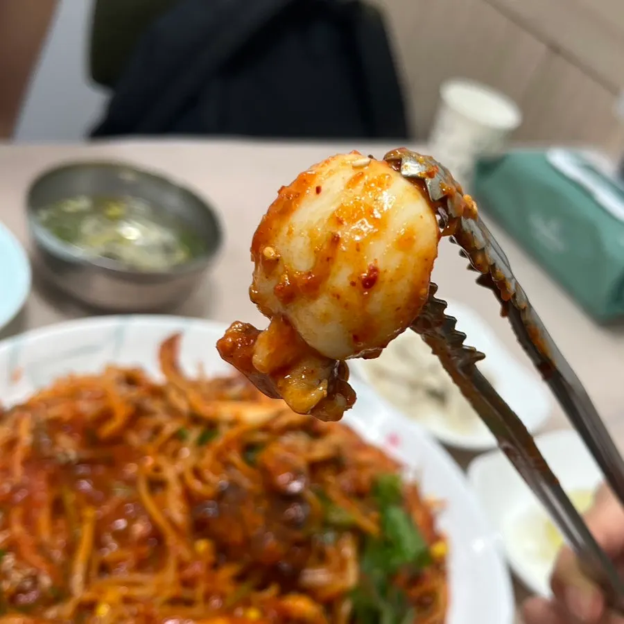Chewy-textured seafood lifted out of the pot