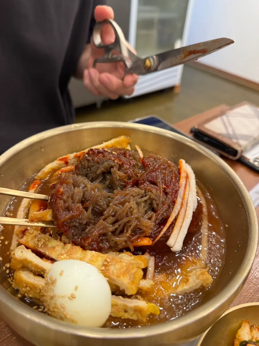 Close-up of mixed naengmyeon noodles after being tossed
