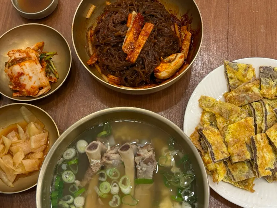 Table spread with bibim naengmyeon and yukjeon together