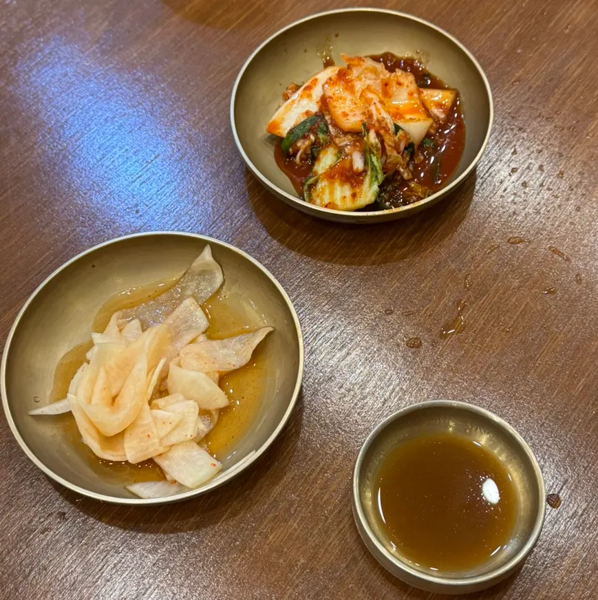Table set with basic side dishes and yukjeon sauce