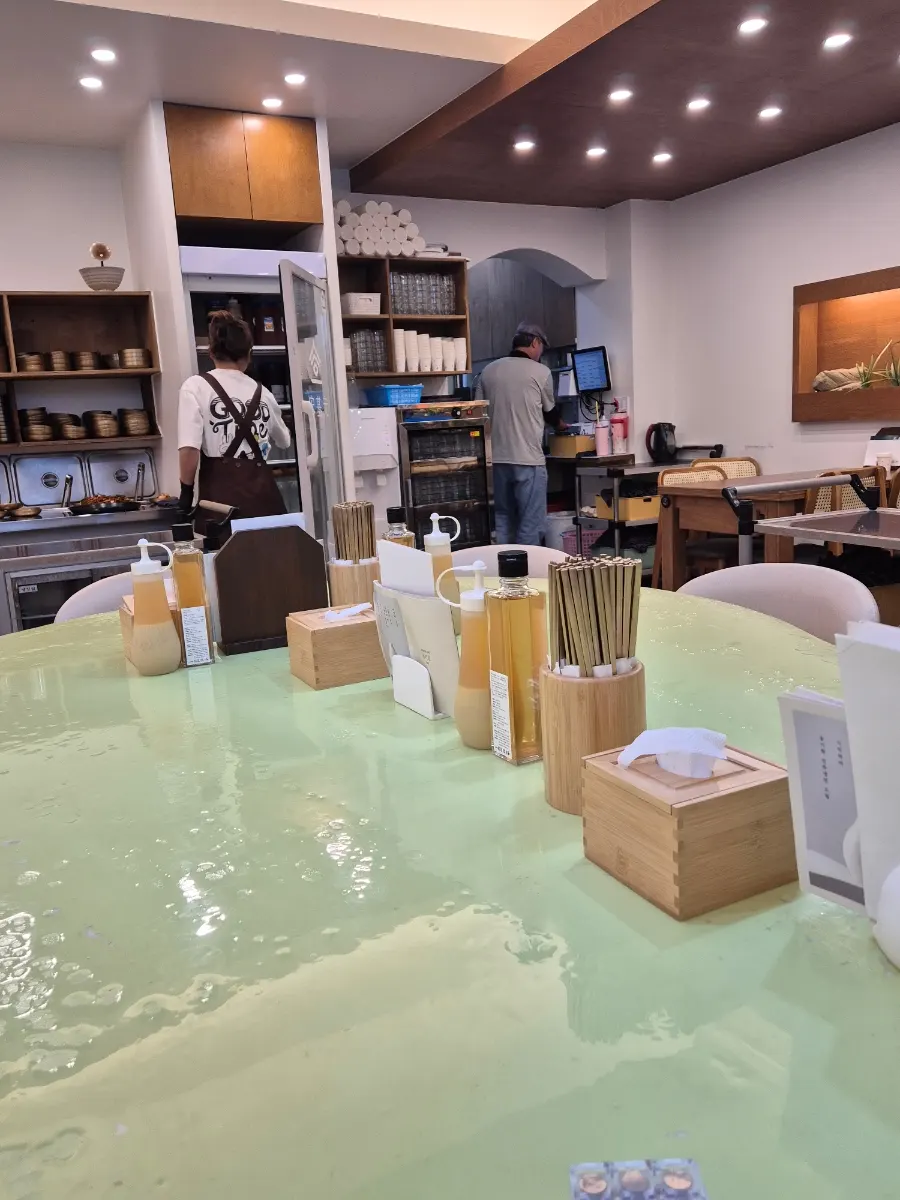 Interior of Song Giwon Jinju Naengmyeon Main Branch with a large central table