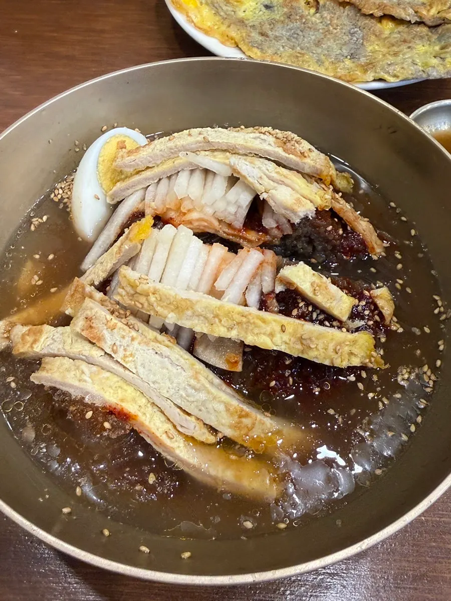 Yukjeon garnish on top of the naengmyeon