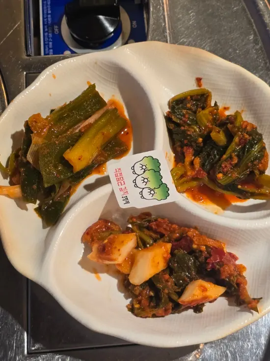 Banchan being set out one by one at the gopchang restaurant