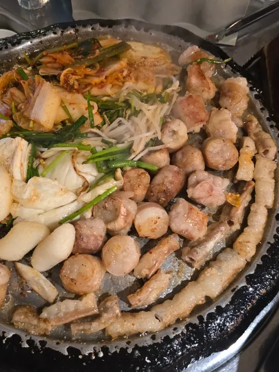 Beef gopchang cooking on the timer-set grill