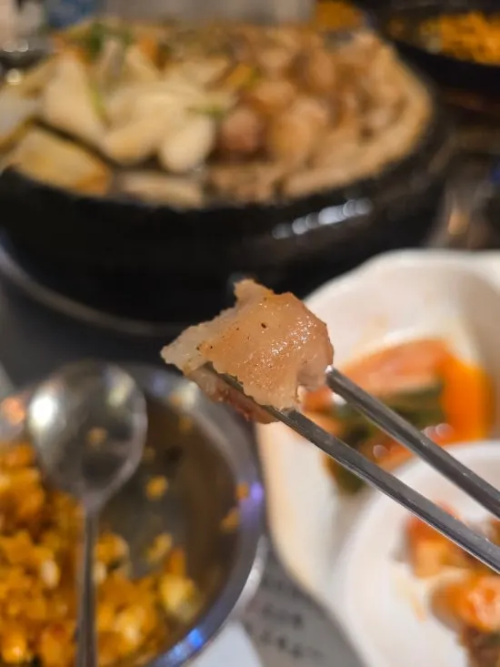 Beef gopchang dipped in minari sauce