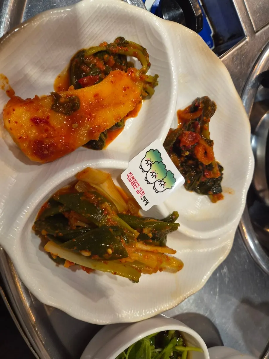 Three types of house-made kimchi: seokbakji, yeolmu, and scallion kimchi