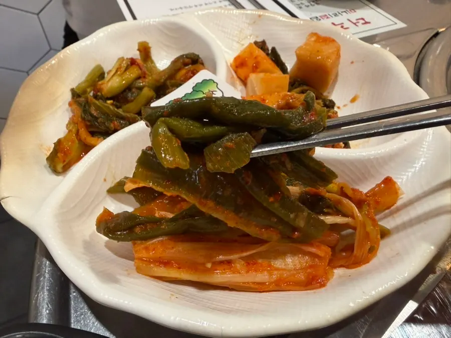 A plate of scallion kimchi also sold to-go