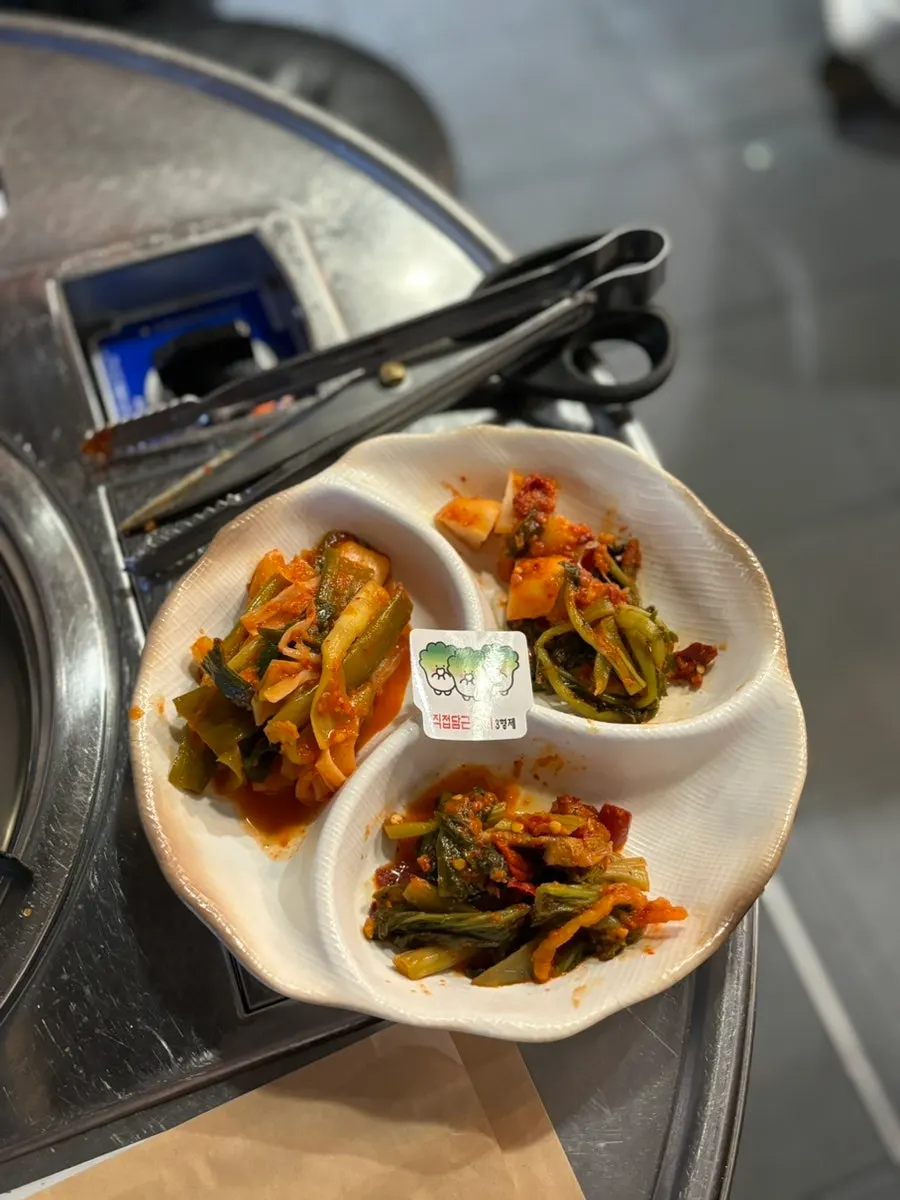 Dipping soy sauce with minari and cheongyang peppers for gopchang