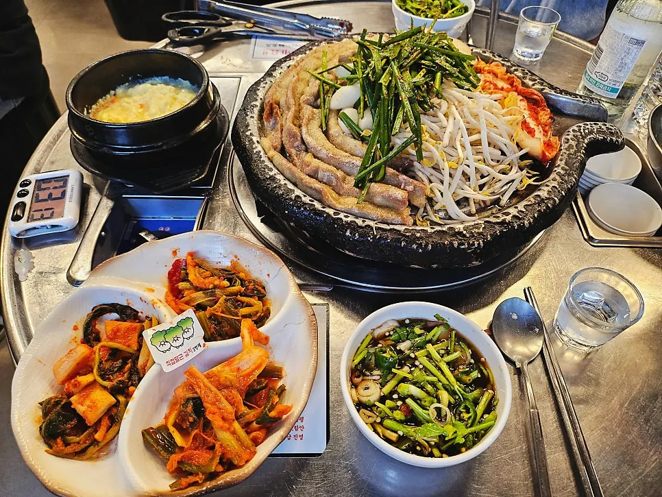 부추와 숙주, 김치, 떡이 함께 오른 불판