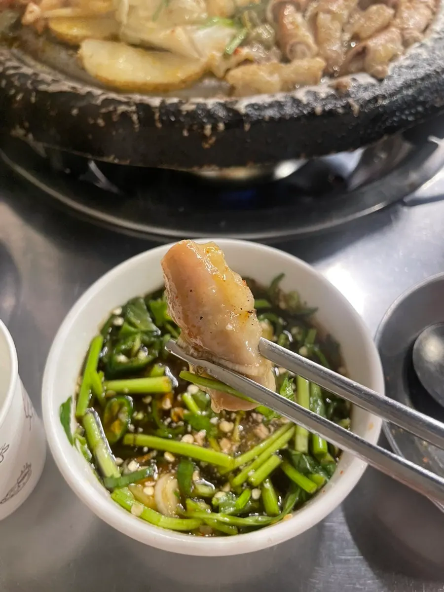 Golden, well-cooked gopchang alongside grilled rice cake and potato