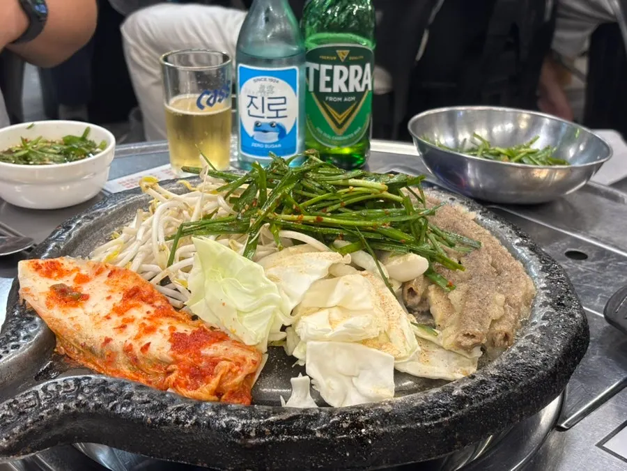 Gopchang served with potato, rice cake and vegetables