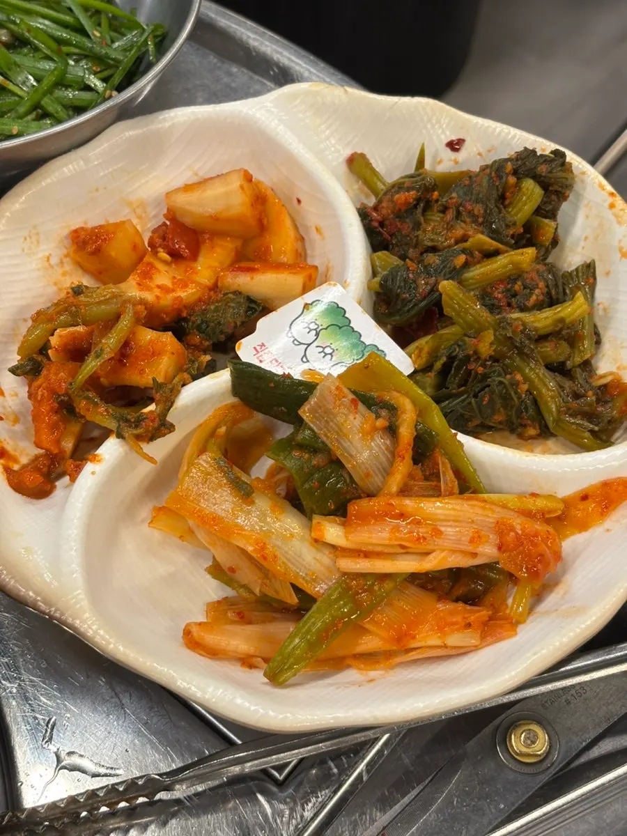 Gopchang and vegetables cooking on the grill