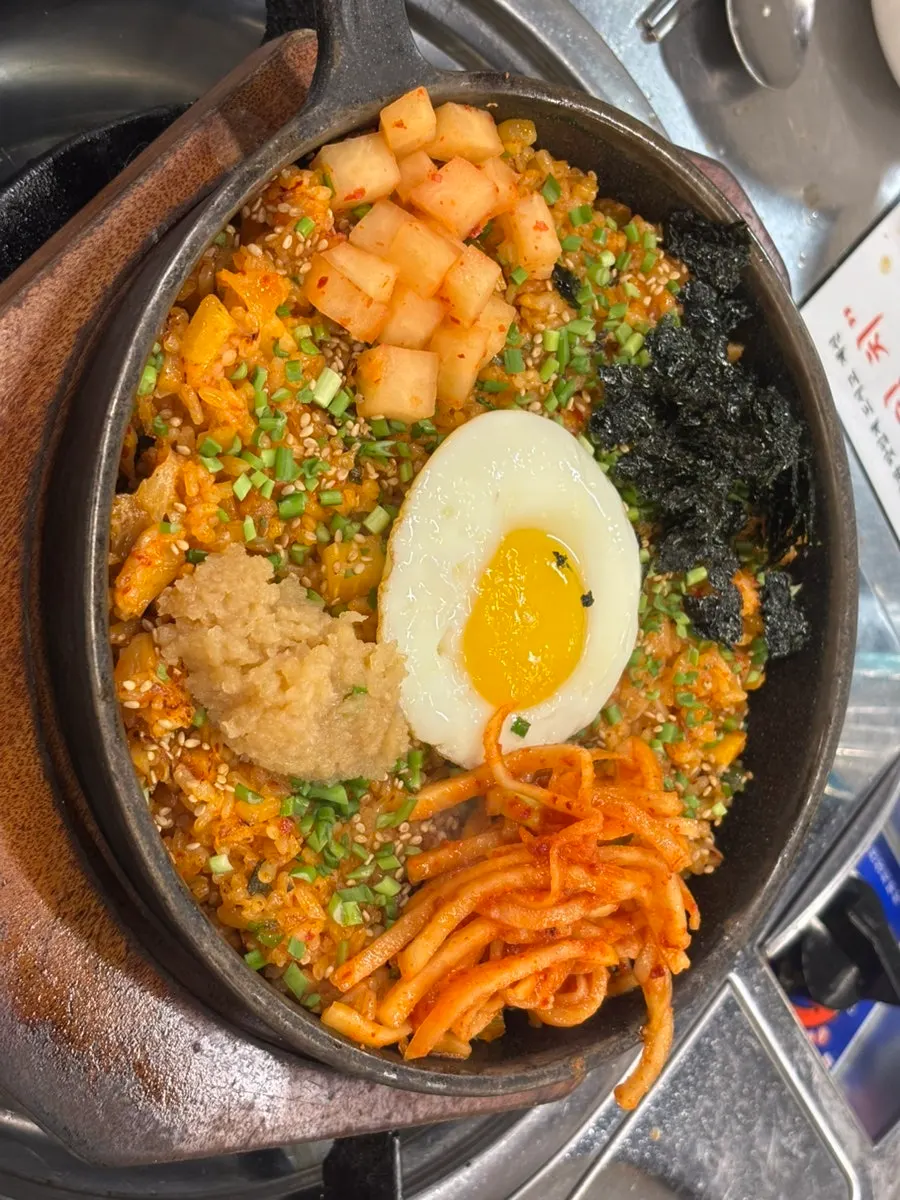 Plate of gopchang topped with grilled kimchi