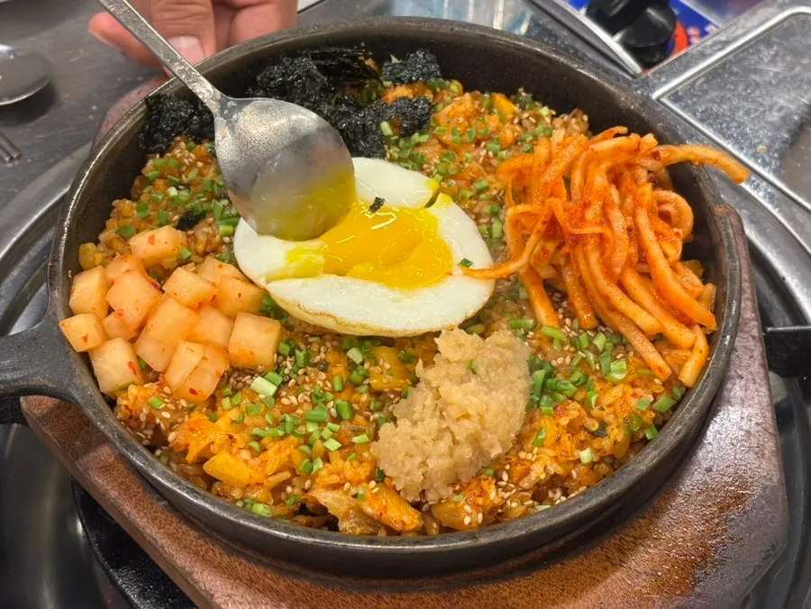 Kkakdugi fried rice topped with a soft fried egg
