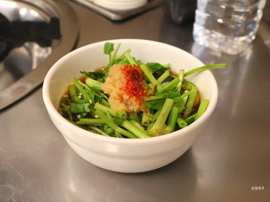 Bowl of minari-garlic sauce served right after being seated