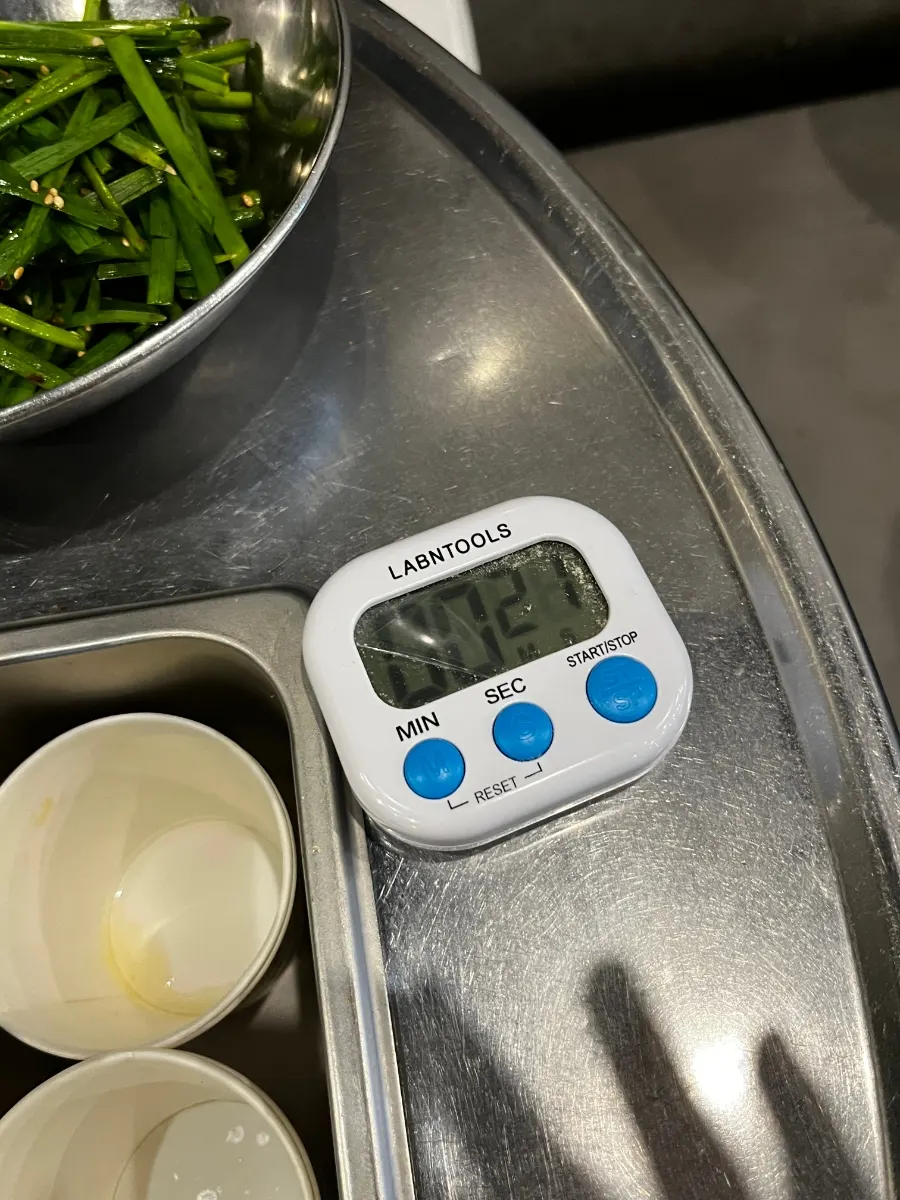 Hanwoo gopchang on the grill with a digital timer