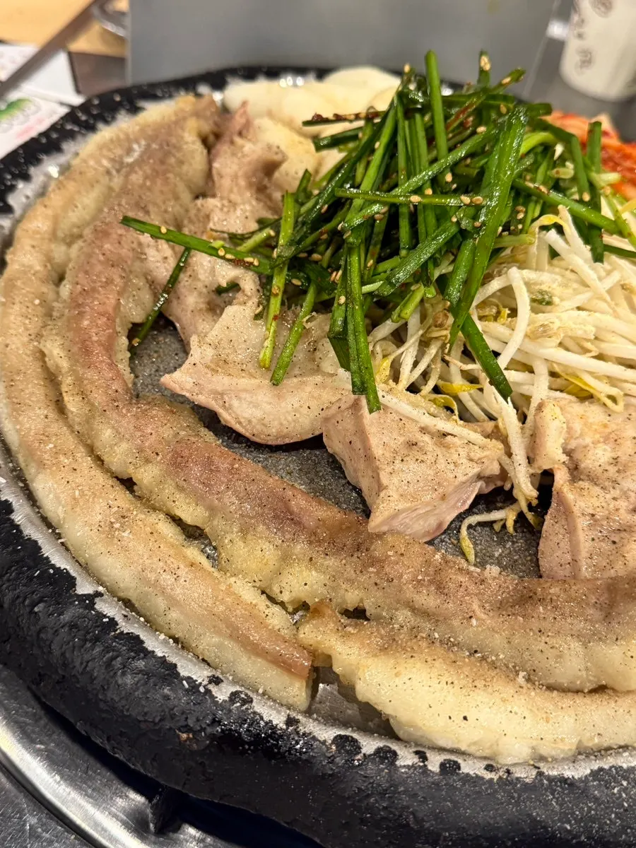 Gopchang and kimchi together on the grill