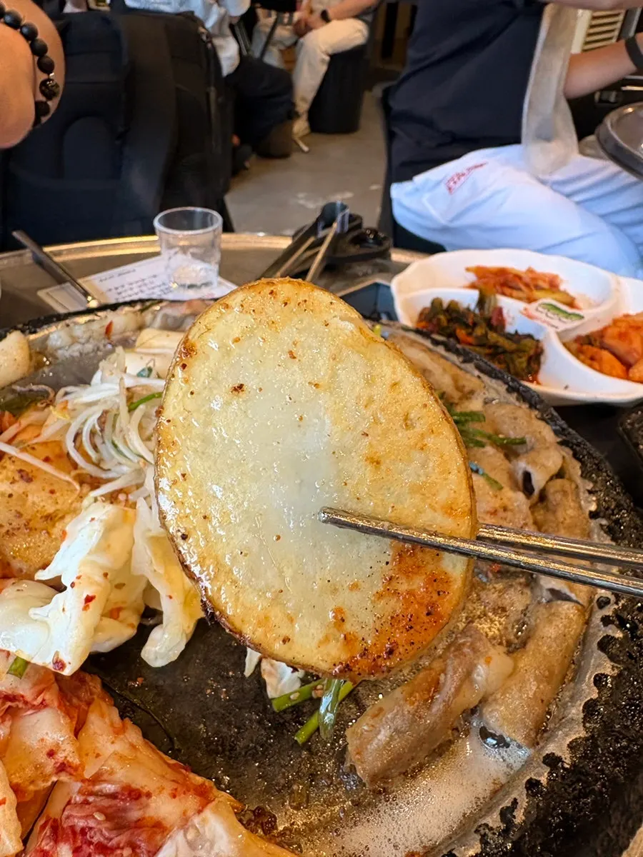 A piece of makchang dipped in sauce