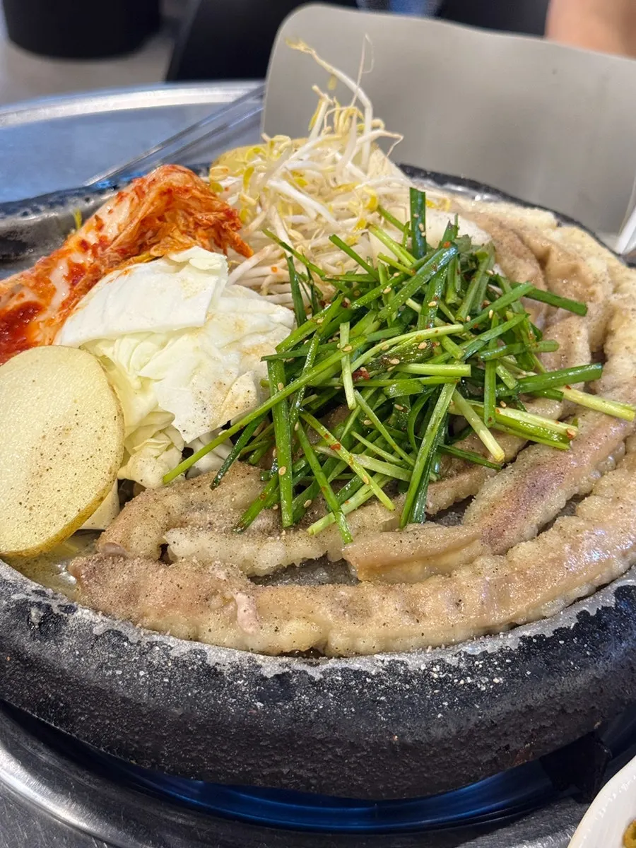 Bean sprouts and cabbage grilling alongside the gopchang