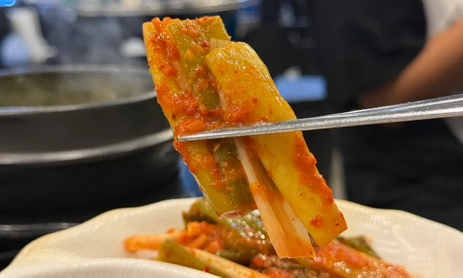 Close-up of mustard leaf, ponytail radish, and green onion kimchi
