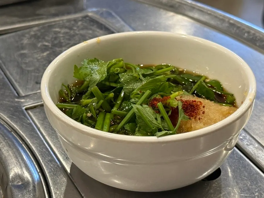 Sauce made with garlic pickle liquid, minari, and sliced chili