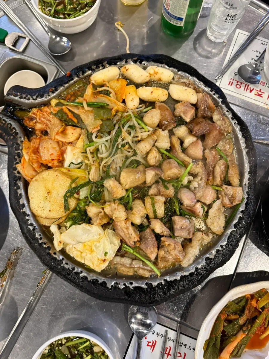 젓가락으로 집어 든 한우곱창 한 점