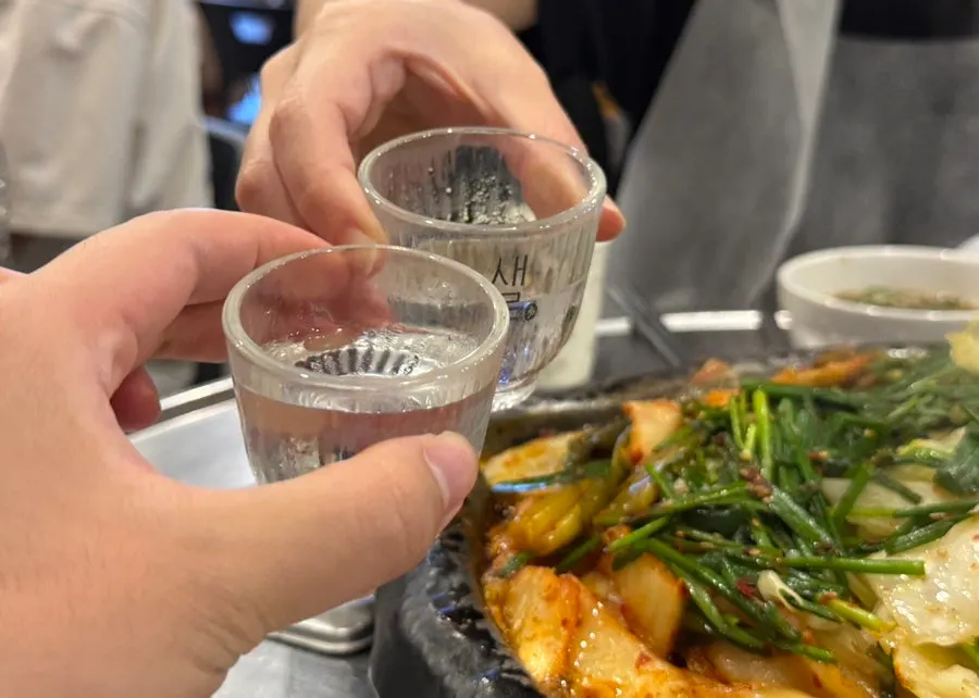 A drink alongside a bite of grilled meat