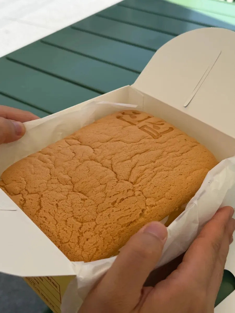 Castella piled generously with whipped cream