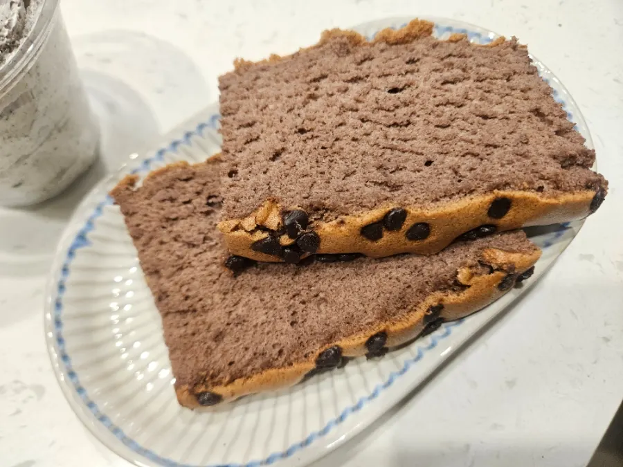 Chocolate castella being spread with the whipped cream single item