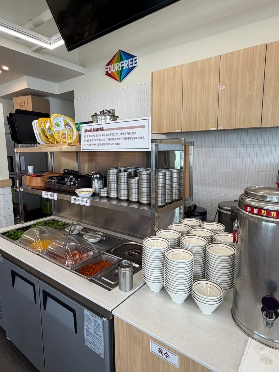 Self-serve bar at Jinsim Wang Donkatsu with plates and cutlery