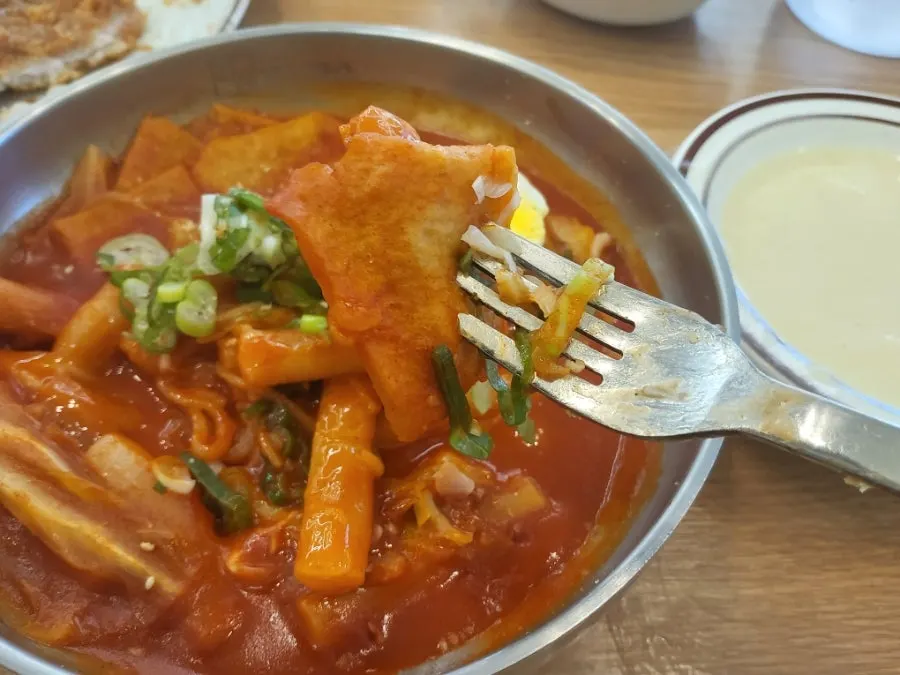 A bite of cutlet dipped in sauce