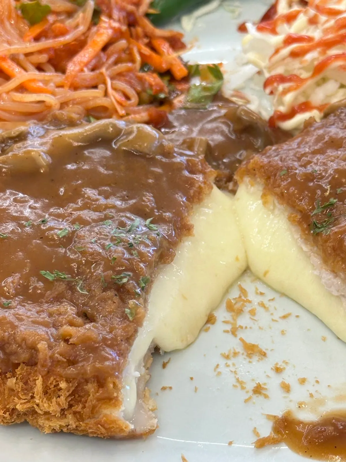 Cheese stretching from the cutlet cut in half