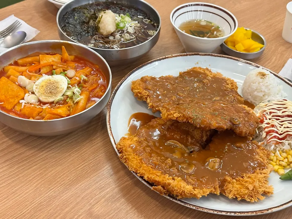 Table set with pork cutlet and side dishes