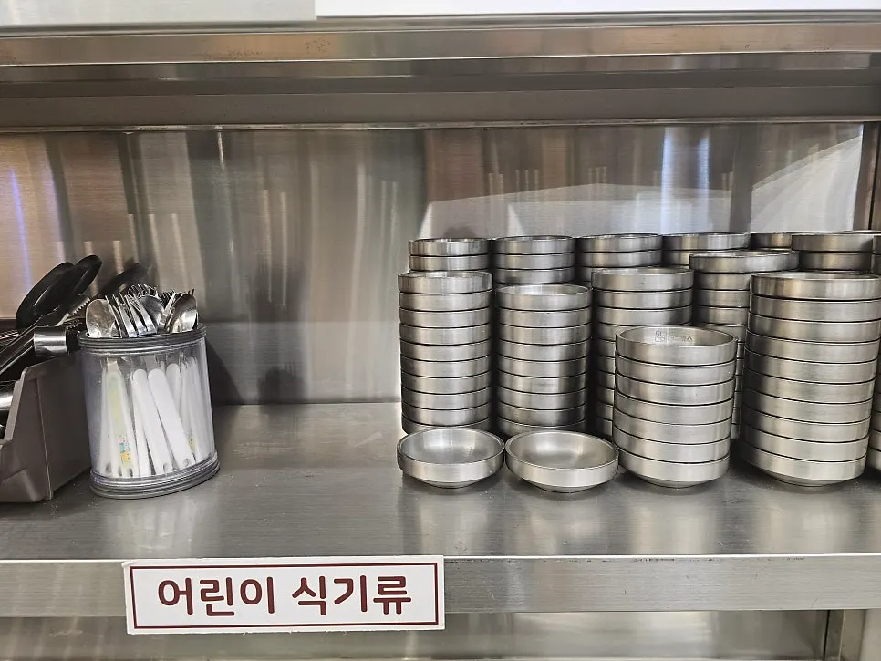 Small plates, spoons, forks and knives at the self-serve bar