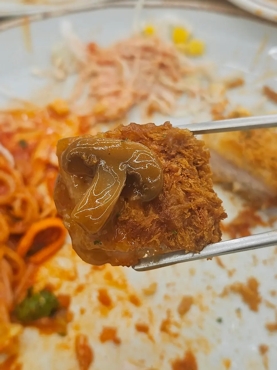 A piece of Cheese Waterfall Katsu paired with sauce