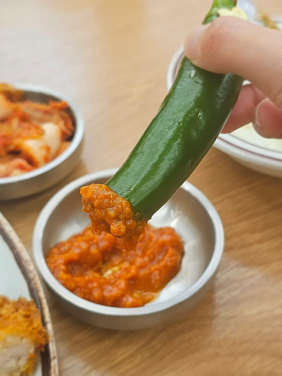 Cabbage salad, kimchi and cucumber peppers on the side
