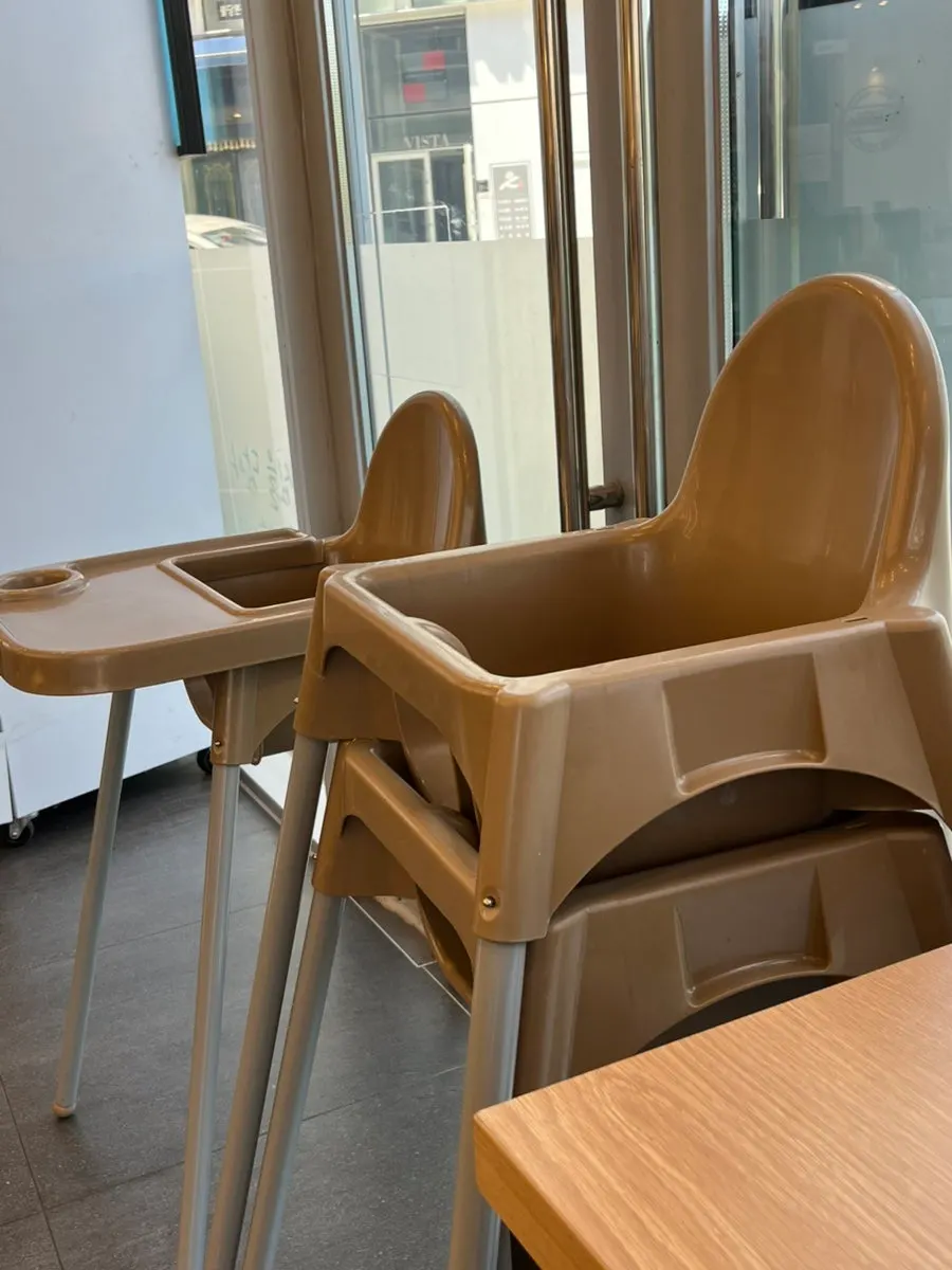 Seating area with a baby chair at Jinsim Wang Donkatsu