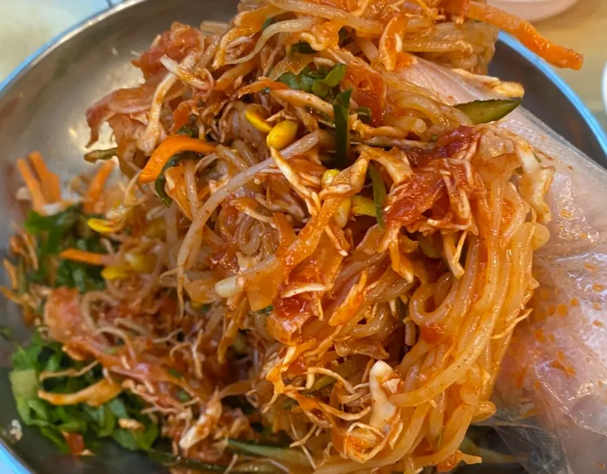Table with pork cutlet and jjolmyeon side by side