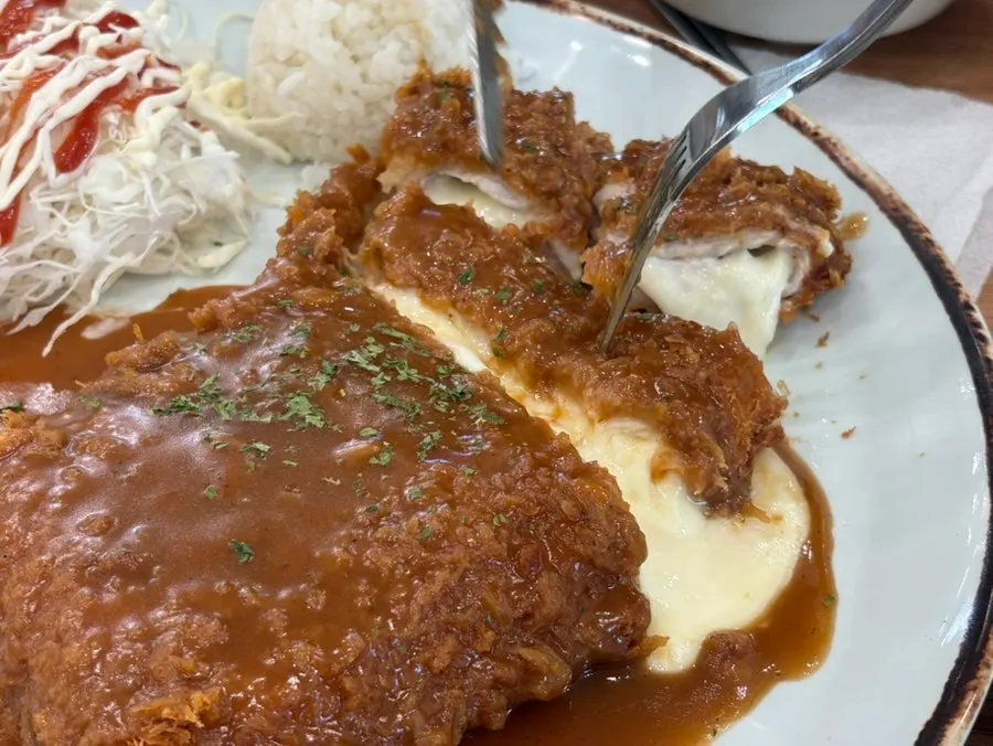 Cheese pouring down from the cheese waterfall pork cutlet
