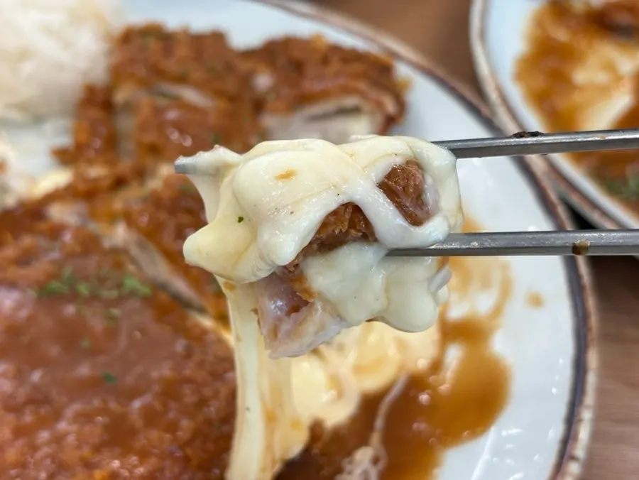 A piece of the cheese-filled cutlet