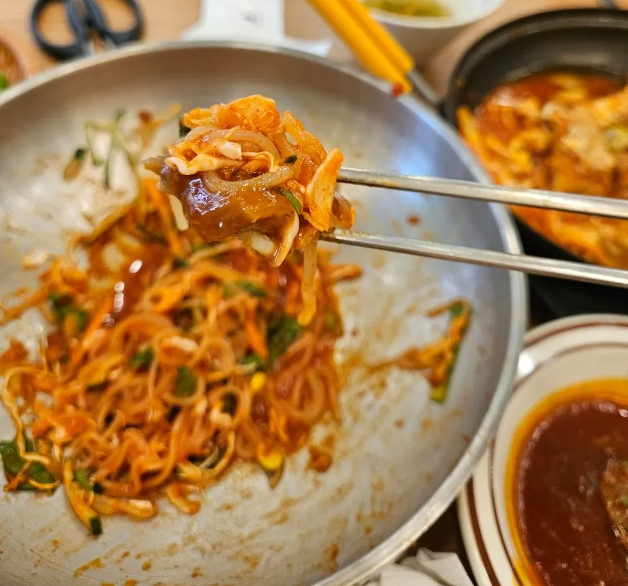 Wang donkkaseu and jjolmyeon laid out together on the table